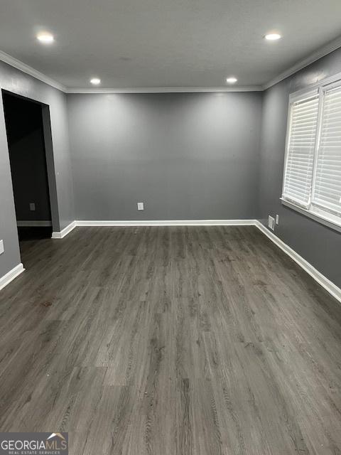 unfurnished room featuring ornamental molding, recessed lighting, baseboards, and dark wood-type flooring