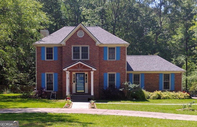 230 Mapledale Trl, Sharpsburg, GA 30277 - colonial house with a front yard, brick siding, and a chimney