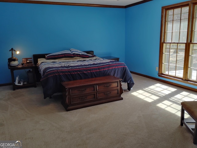 bedroom featuring baseboards, ornamental molding, and light colored carpet