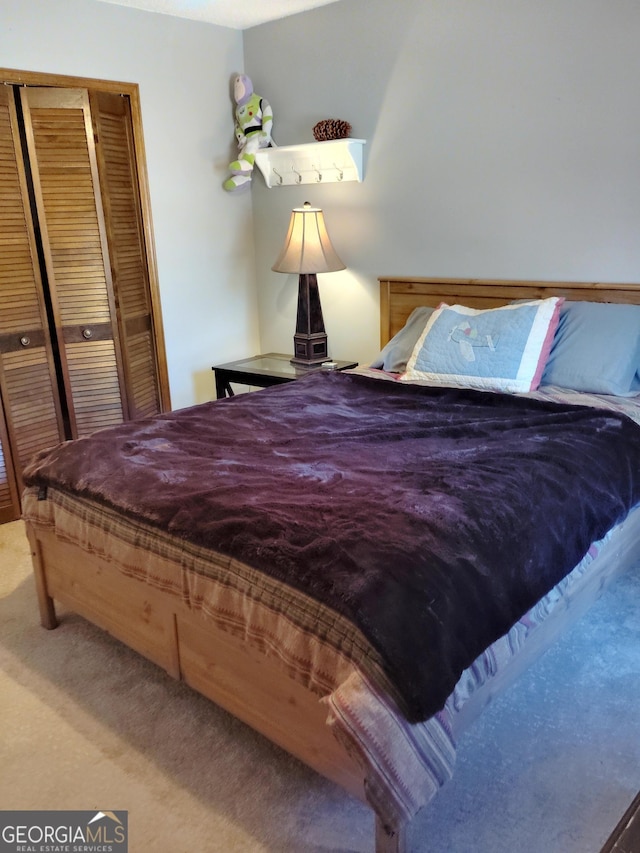 carpeted bedroom featuring a closet