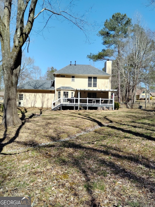230 Mapledale Trl, Sharpsburg, GA 30277 - rear view of house featuring a chimney and a wooden deck