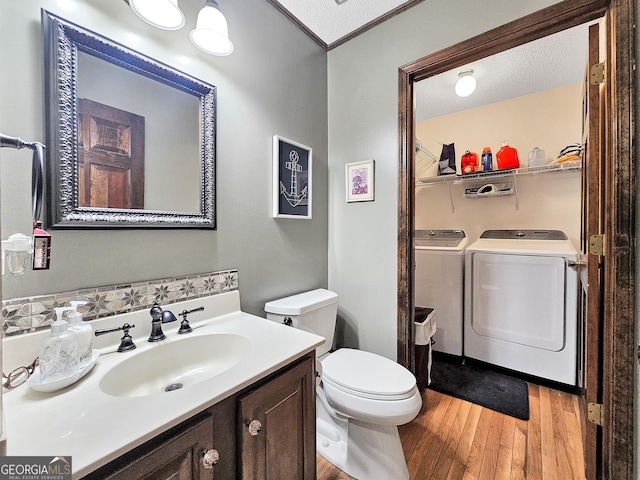 230 Mapledale Trl, Sharpsburg, GA 30277 - bathroom with washing machine and dryer, wood finished floors, toilet, and vanity