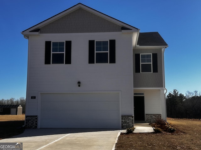 view of front of house featuring an attached garage, concrete driveway, and brick siding