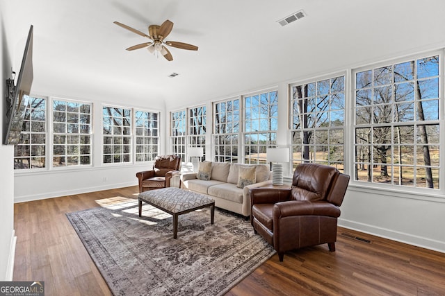 sunroom / solarium with visible vents and a ceiling fan