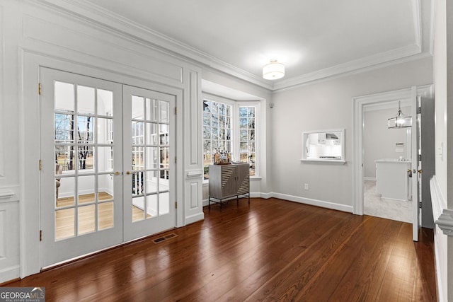 doorway with ornamental molding, visible vents, dark wood finished floors, and french doors