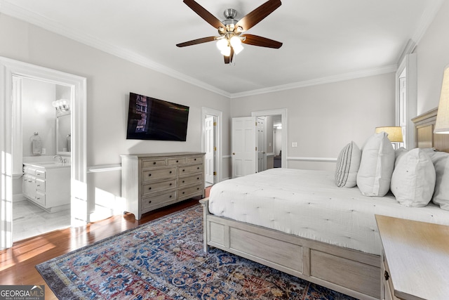 bedroom with connected bathroom, ceiling fan, ornamental molding, wood finished floors, and a sink