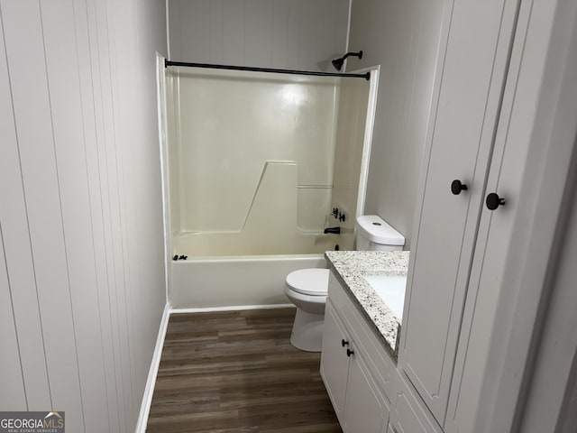 bathroom featuring toilet,  shower combination, wood finished floors, and vanity