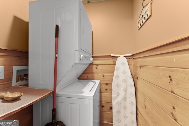 clothes washing area featuring laundry area and stacked washer and clothes dryer