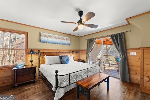 bedroom with dark wood-style floors, access to outside, and wainscoting