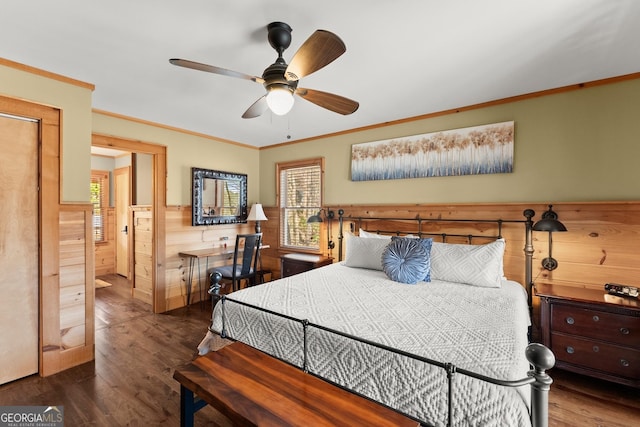 bedroom with a wainscoted wall, crown molding, dark wood-style flooring, and wood walls