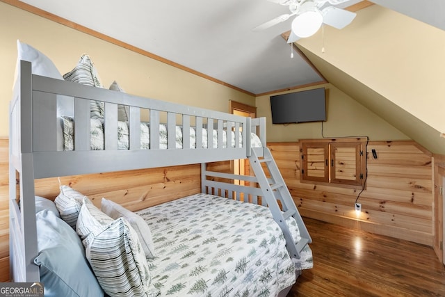 bedroom featuring dark wood-style floors, crown molding, vaulted ceiling, and a ceiling fan