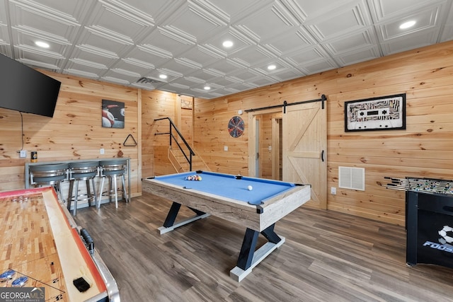 playroom featuring an ornate ceiling, a barn door, visible vents, and wood finished floors