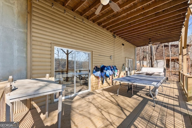 deck with outdoor dining space and ceiling fan