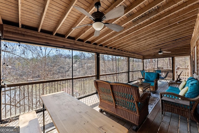 sunroom / solarium featuring wooden ceiling, ceiling fan, and beam ceiling