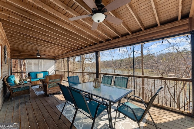 unfurnished sunroom featuring wood ceiling, ceiling fan, and beam ceiling