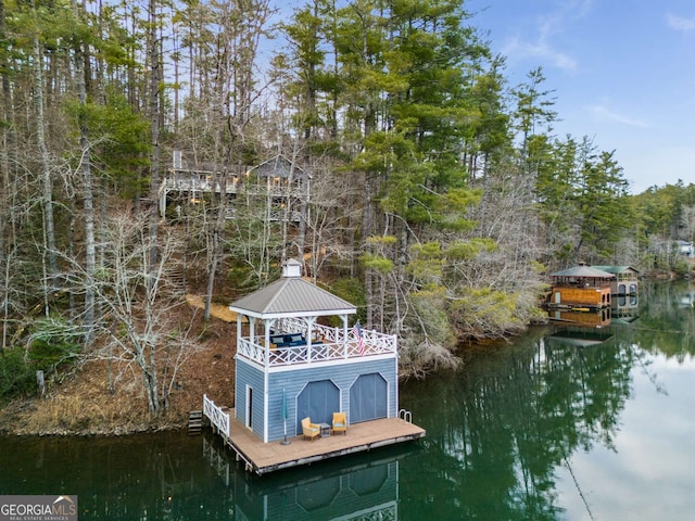 view of dock with a water view and a gazebo