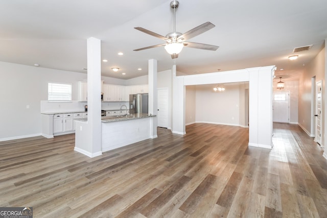 kitchen with visible vents, white cabinets, wood finished floors, and stainless steel fridge with ice dispenser