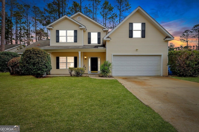 traditional-style house with an attached garage, concrete driveway, and a front yard