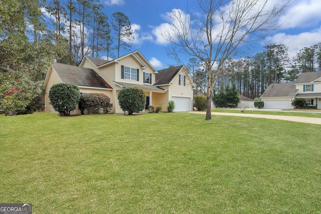 view of front of house featuring driveway, an attached garage, and a front yard