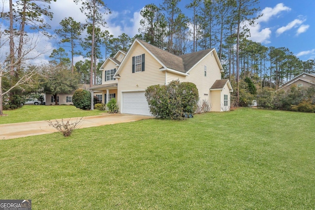 view of side of home with a yard, driveway, and an attached garage