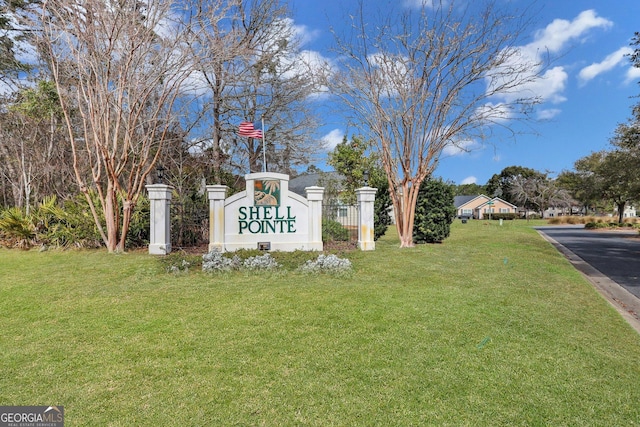 community / neighborhood sign with a yard