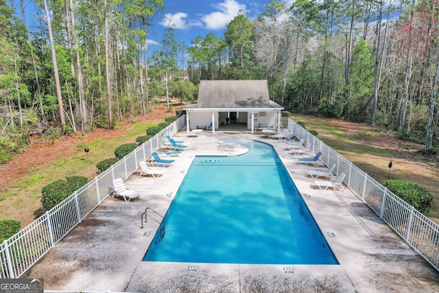 pool featuring a patio and fence