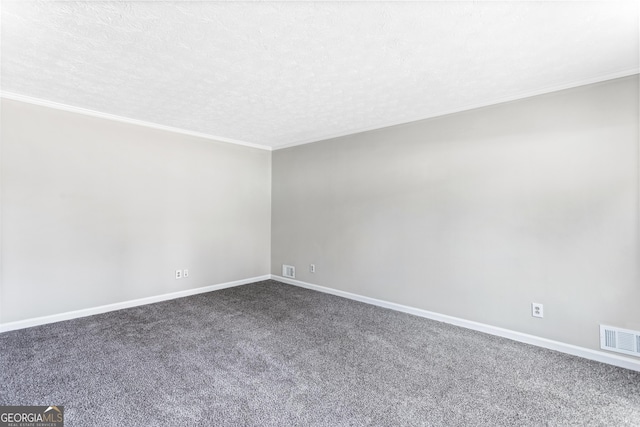 carpeted spare room with baseboards, crown molding, visible vents, and a textured ceiling