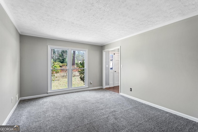 unfurnished room featuring ornamental molding, dark carpet, a textured ceiling, and baseboards