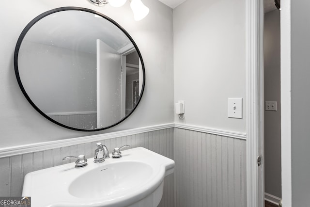 bathroom with a sink and wainscoting