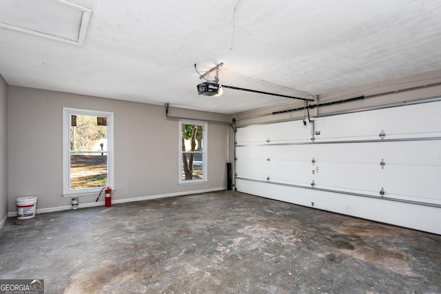 garage with baseboards and a garage door opener