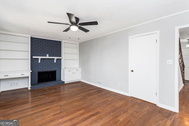 unfurnished living room with crown molding, dark wood-style flooring, visible vents, and a fireplace