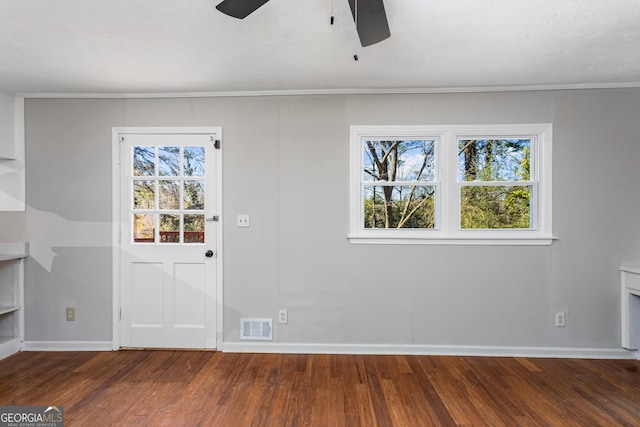 interior space with dark wood-style floors, a wealth of natural light, and visible vents