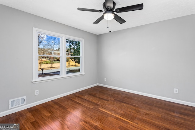 spare room featuring visible vents, baseboards, and hardwood / wood-style flooring