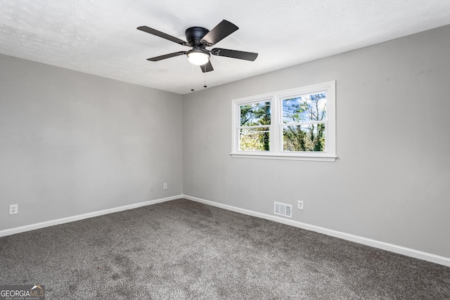 carpeted empty room featuring visible vents, ceiling fan, a textured ceiling, and baseboards