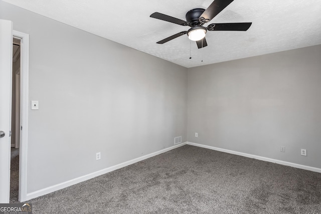 carpeted empty room with visible vents, baseboards, and a textured ceiling