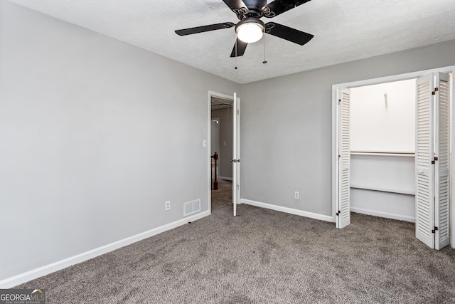 unfurnished bedroom featuring carpet, visible vents, baseboards, and a textured ceiling