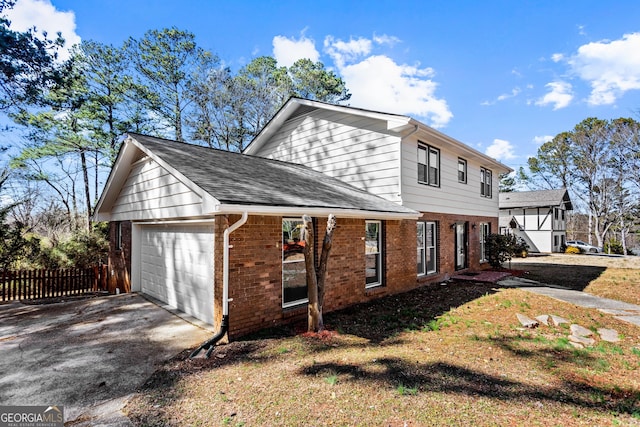 view of property exterior with an attached garage, brick siding, fence, concrete driveway, and roof with shingles