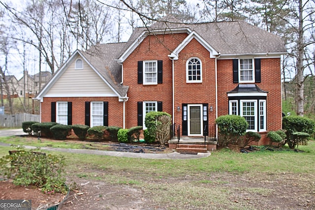 colonial inspired home with brick siding