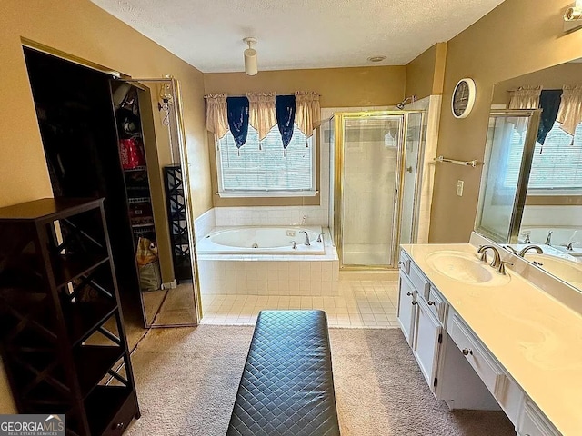 bathroom with a garden tub, tile patterned flooring, a textured ceiling, vanity, and a shower stall