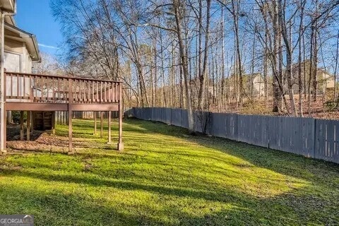 view of yard featuring a fenced backyard and a deck