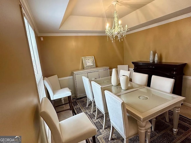 dining space featuring crown molding, a tray ceiling, and an inviting chandelier