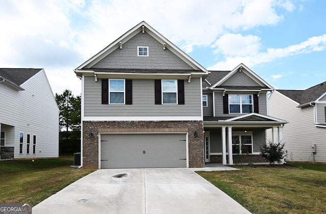 craftsman house featuring a front lawn, concrete driveway, and brick siding