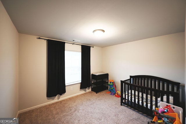 bedroom with carpet, visible vents, and baseboards