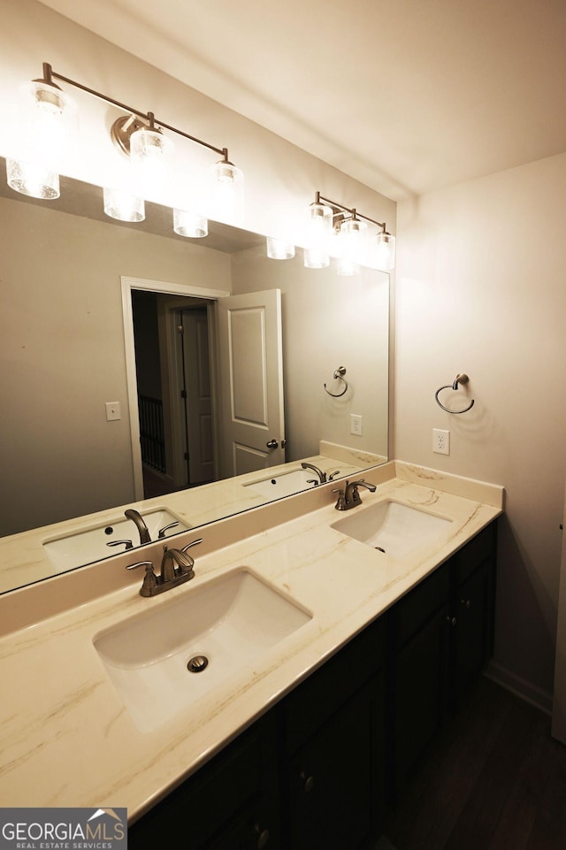 full bathroom with a sink and double vanity