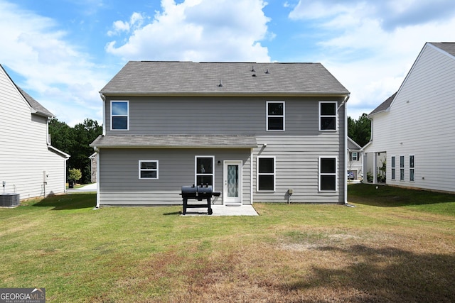 rear view of property featuring a patio area, a lawn, and central AC