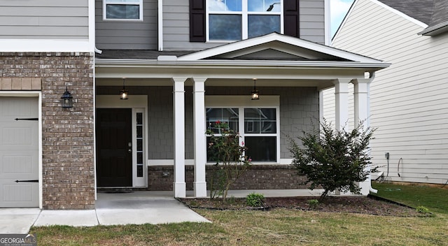 property entrance with covered porch and brick siding