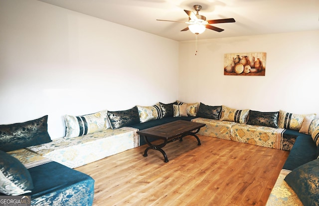 living room featuring ceiling fan and wood finished floors