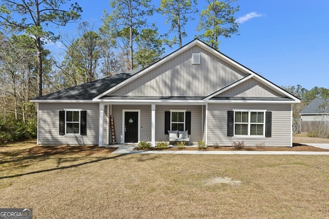 view of front of property featuring a porch and a front lawn