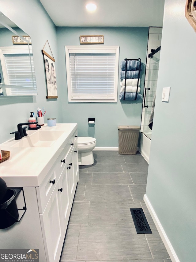 bathroom with visible vents, baseboards, toilet, vanity, and washtub / shower combination