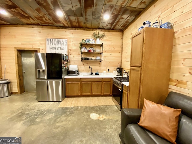 kitchen with stainless steel appliances, brown cabinetry, light countertops, and a sink